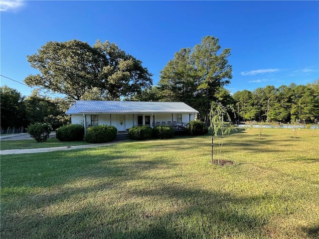 ranch-style home with covered porch and a front yard