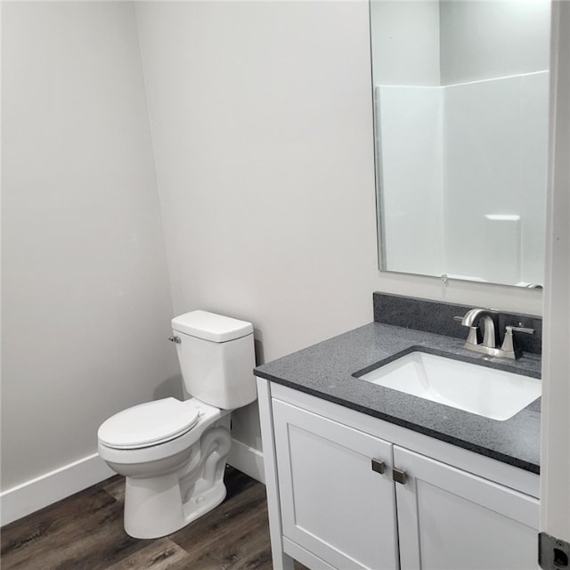 bathroom with vanity, hardwood / wood-style flooring, and toilet