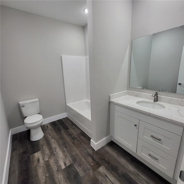 full bathroom with hardwood / wood-style flooring, vanity, toilet, and bathtub / shower combination