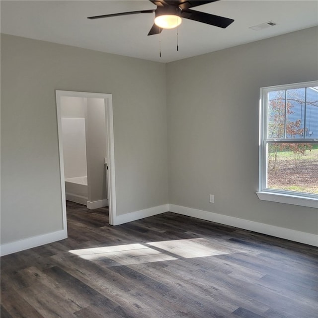 spare room with dark hardwood / wood-style floors and ceiling fan