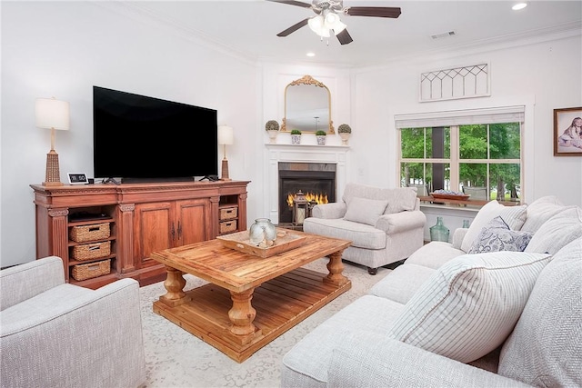 2131 Preserve Dr, Auburn, AL 36879 - living room featuring ceiling fan, crown molding, a warm lit fireplace, and recessed lighting