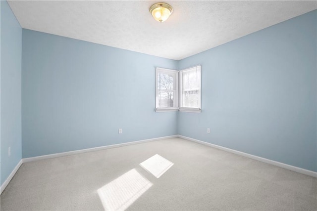 unfurnished room featuring light carpet