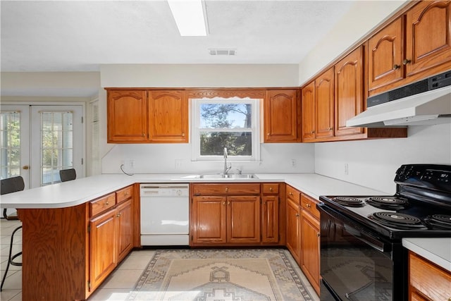 605 Lockwood St, Auburn, AL 36830 - kitchen with black electric range oven, under cabinet range hood, visible vents, white dishwasher, and a sink