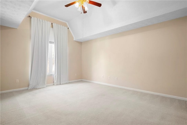 unfurnished room featuring lofted ceiling, carpet flooring, and ceiling fan