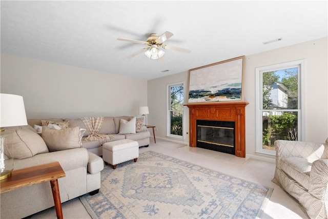 605 Lockwood St, Auburn, AL 36830 - living area featuring a fireplace with flush hearth, light carpet, a ceiling fan, and visible vents