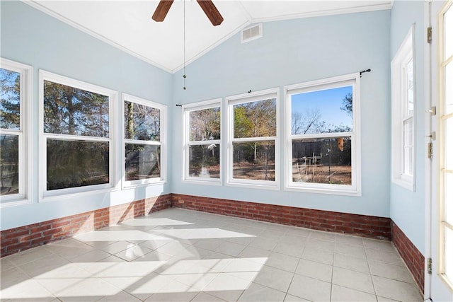 unfurnished sunroom featuring ceiling fan, vaulted ceiling, and a wealth of natural light