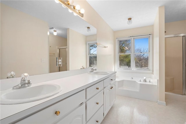 bathroom with vanity and independent shower and bath