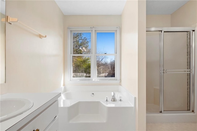 bathroom featuring vanity and shower with separate bathtub