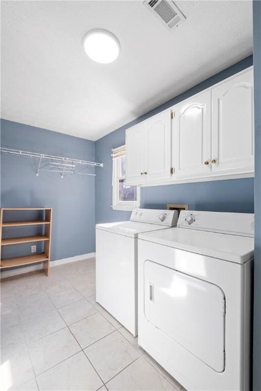 605 Lockwood St, Auburn, AL 36830 - laundry room featuring visible vents, baseboards, light tile patterned floors, separate washer and dryer, and cabinet space