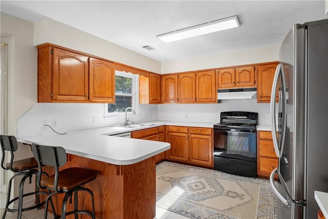 605 Lockwood St, Auburn, AL 36830 - kitchen featuring freestanding refrigerator, electric range, a peninsula, visible vents, and under cabinet range hood