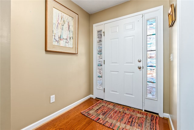 foyer entrance with hardwood / wood-style flooring