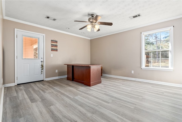 unfurnished office featuring a textured ceiling, ceiling fan, crown molding, and light hardwood / wood-style floors