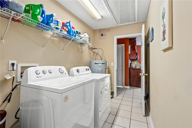 laundry room featuring water heater, separate washer and dryer, and light tile patterned floors