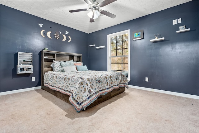 carpeted bedroom with a textured ceiling and ceiling fan