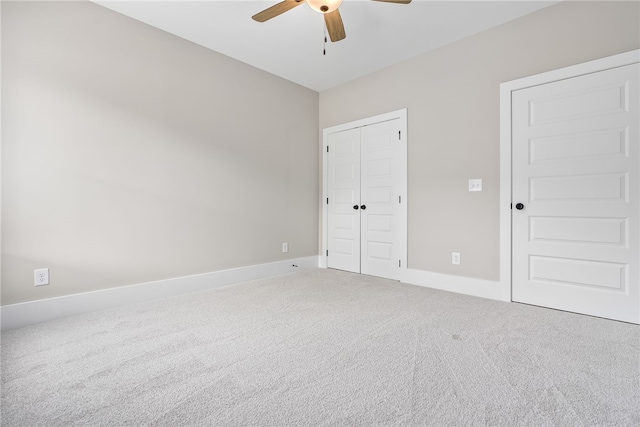 unfurnished bedroom featuring ceiling fan, carpet floors, a closet, and baseboards