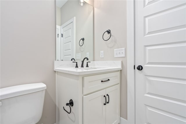 bathroom with toilet and vanity