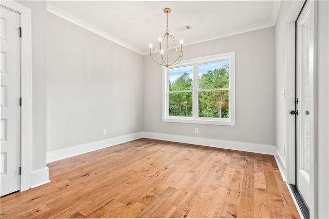 empty room featuring a notable chandelier, crown molding, light wood-style flooring, and baseboards