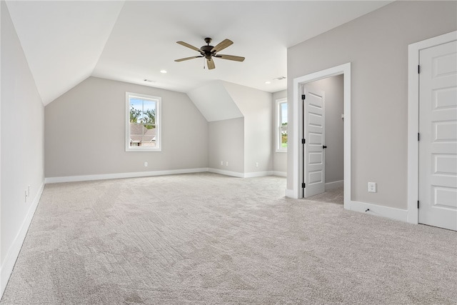 bonus room with lofted ceiling, carpet floors, a ceiling fan, and baseboards