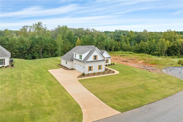 bird's eye view with a wooded view