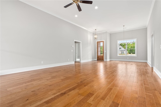 unfurnished room with crown molding, light wood-type flooring, ceiling fan, and baseboards