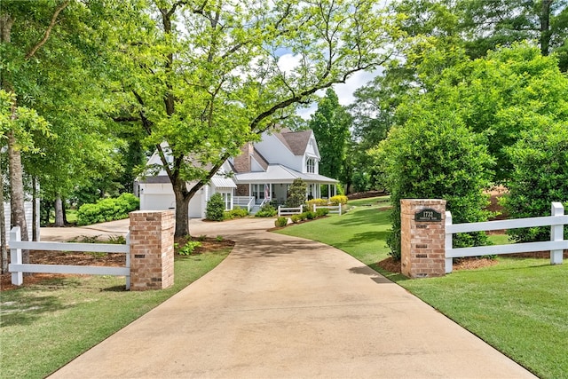 view of front of house with a porch and a front lawn