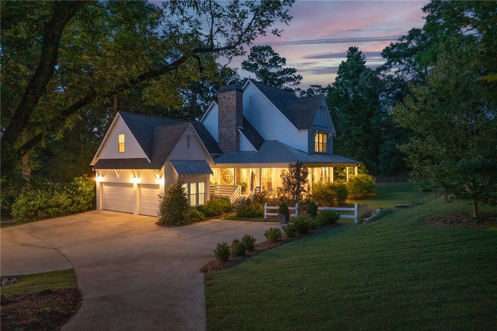 1732 W Farmville Rd, Auburn, AL 36879 - view of front of home featuring a yard, a garage, driveway, and a chimney