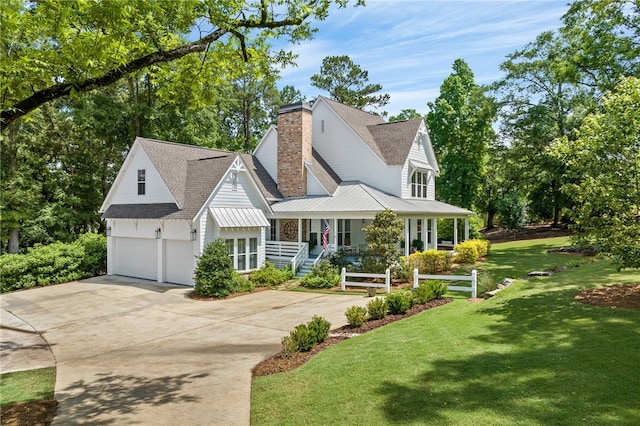 view of front of home with a garage, a porch, and a front yard