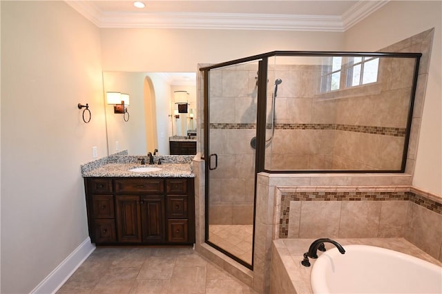 bathroom featuring a bath, vanity, a stall shower, and ornamental molding