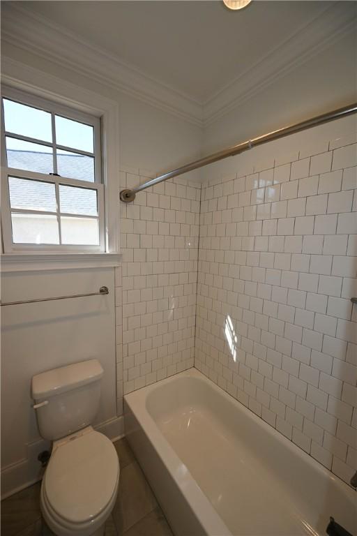 full bath featuring bathtub / shower combination, toilet, and crown molding