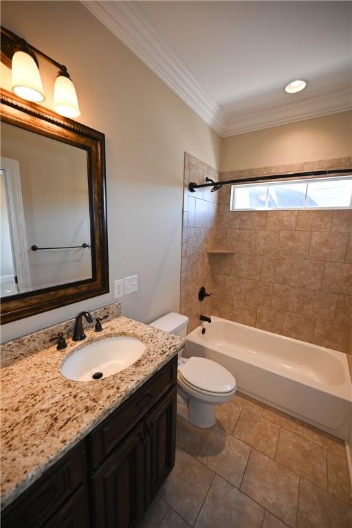 bathroom with  shower combination, ornamental molding, toilet, and vanity