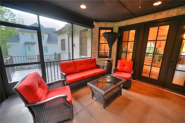 sunroom / solarium with a healthy amount of sunlight and french doors