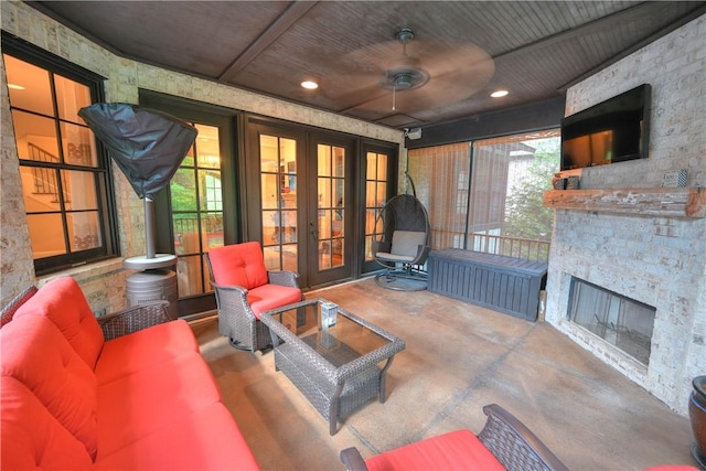 view of patio / terrace featuring ceiling fan, french doors, and an outdoor living space with a fireplace