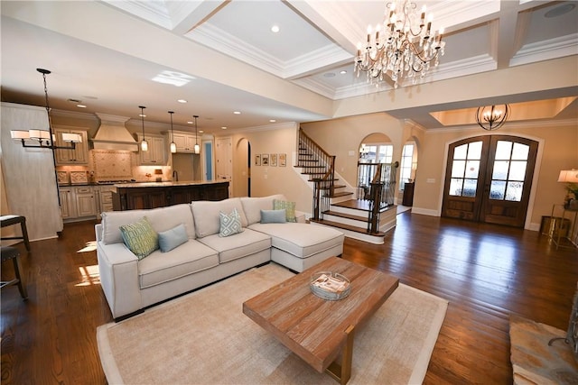 living area with arched walkways, french doors, stairway, an inviting chandelier, and dark wood-type flooring