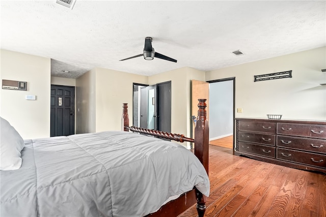 608 Edgewood Dr, Auburn, AL 36830 - bedroom with light wood-style floors, ceiling fan, and a textured ceiling