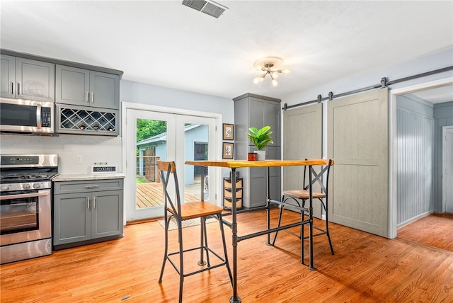 608 Edgewood Dr, Auburn, AL 36830 - dining area with a barn door and light wood-style flooring