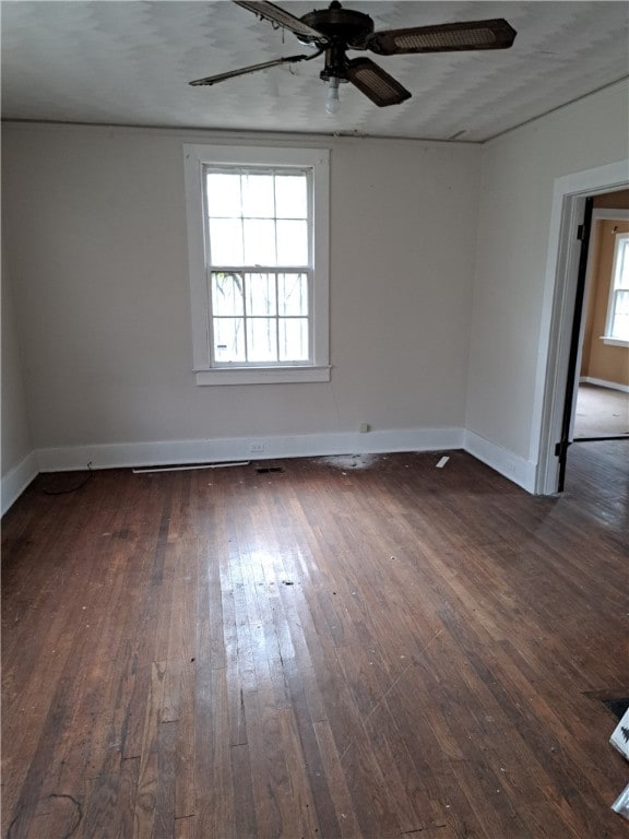 spare room with ceiling fan, baseboards, and hardwood / wood-style flooring