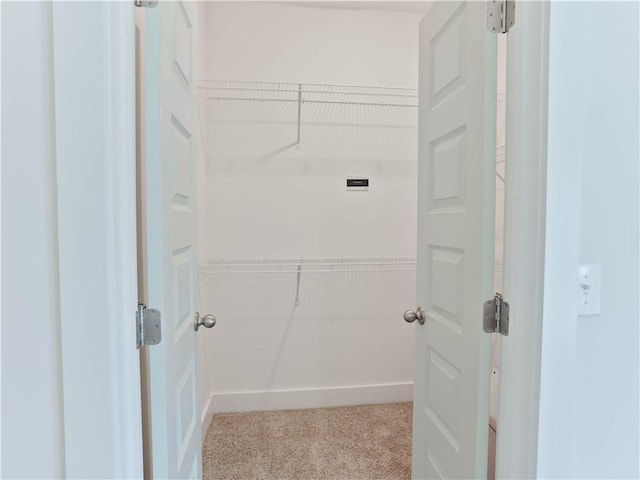 clothes washing area featuring light colored carpet