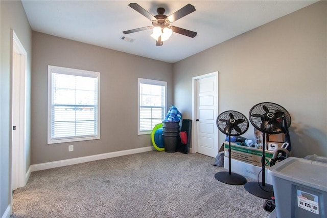 miscellaneous room featuring carpet floors, visible vents, ceiling fan, and baseboards