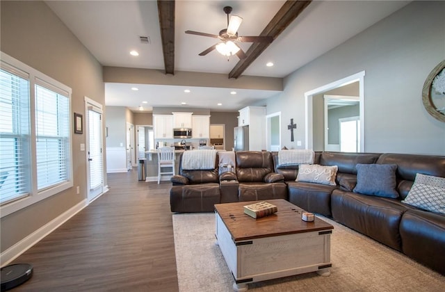 living area featuring dark wood finished floors, recessed lighting, visible vents, beamed ceiling, and baseboards