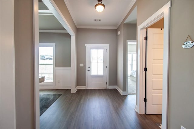 entryway featuring baseboards, dark wood-type flooring, visible vents, and crown molding