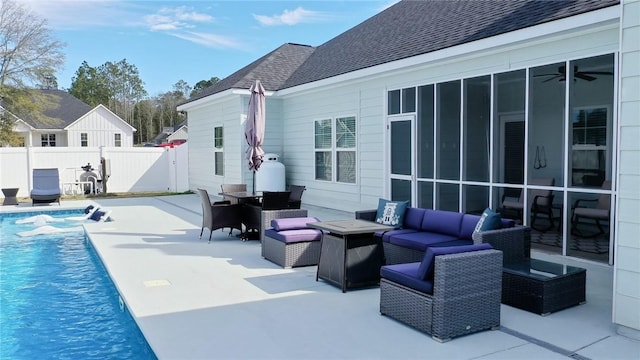 exterior space featuring a sunroom, outdoor lounge area, fence, and a fenced in pool