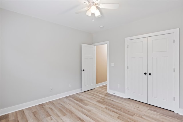 unfurnished bedroom featuring ceiling fan, a closet, and light hardwood / wood-style flooring