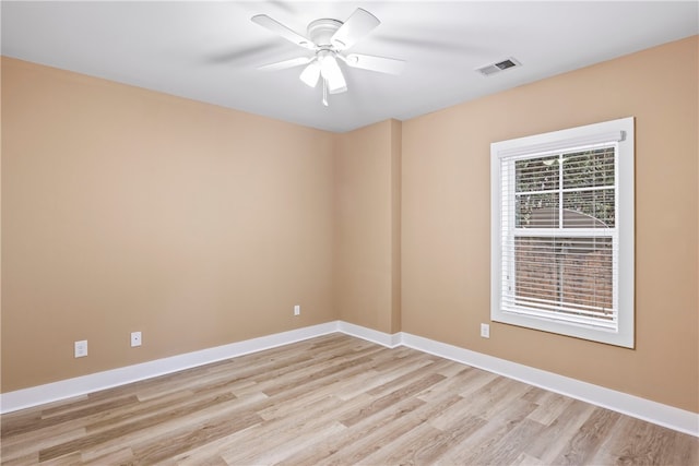 empty room with ceiling fan and light hardwood / wood-style floors