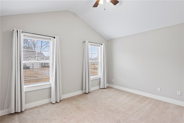 carpeted empty room featuring lofted ceiling and ceiling fan