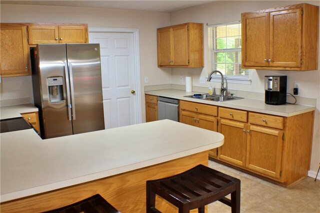 50 Cricket Rdg, Tallassee, AL 36078 - kitchen featuring stainless steel appliances, a sink, light countertops, a peninsula, and light tile patterned floors