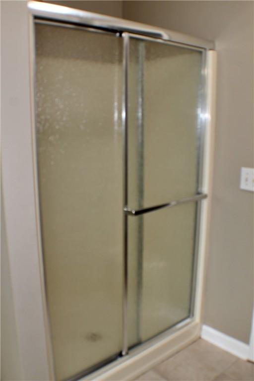 50 Cricket Rdg, Tallassee, AL 36078 - bathroom with a shower with door, baseboards, and tile patterned floors