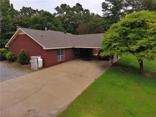 50 Cricket Rdg, Tallassee, AL 36078 - single story home featuring concrete driveway, brick siding, a shingled roof, and a front lawn