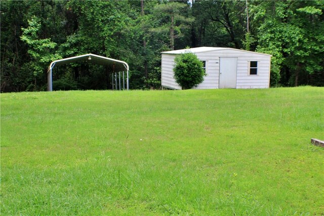 50 Cricket Rdg, Tallassee, AL 36078 - view of green lawn featuring a storage unit, a detached carport, and an outdoor structure