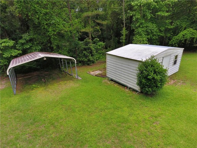 50 Cricket Rdg, Tallassee, AL 36078 - view of green lawn with a detached carport and a view of trees