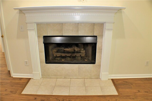 50 Cricket Rdg, Tallassee, AL 36078 - detailed view of wood finished floors, a tiled fireplace, and baseboards